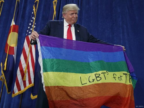 trump holds up gay flag
