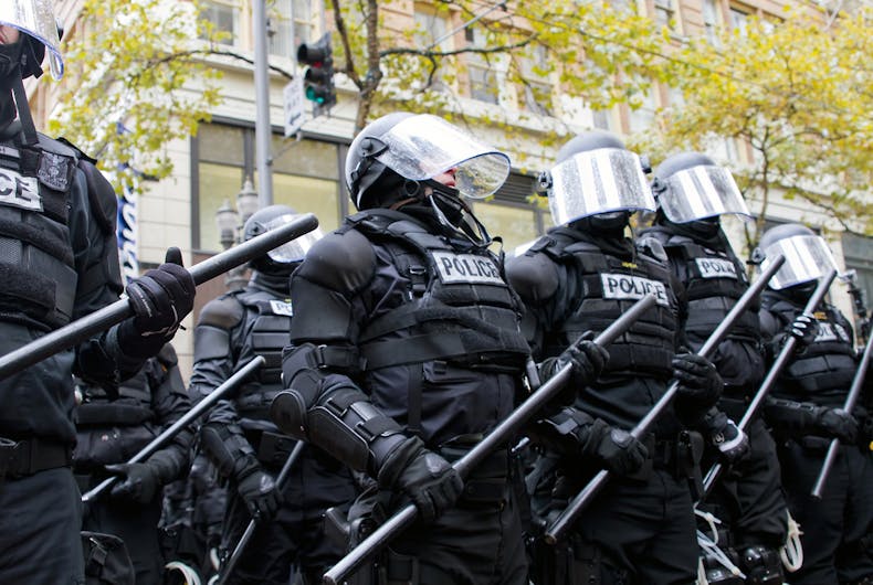 Police in riot gear hold the line in Downtown Portland, Oregon during an Occupy Portland protest on the first anniversary of Occupy Wall Street November 17, 2011