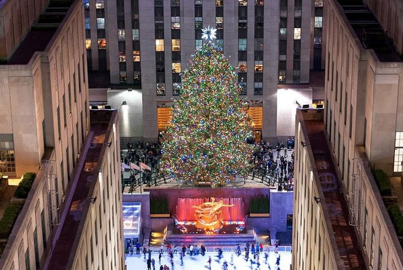 rockefeller-center-tree A Christmas tree at the Rockefeller Center flanked by buildings and next to an ice skating rink